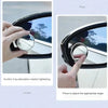 A hand is shown pressing a blind spot mirror on a car window to adjust the angle for suction cup adsorption.
