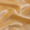 Close-up of luxurious gold fabric with a feather jacquard pattern