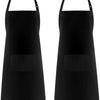 A pair of solid black adjustable kitchen aprons with pockets.
