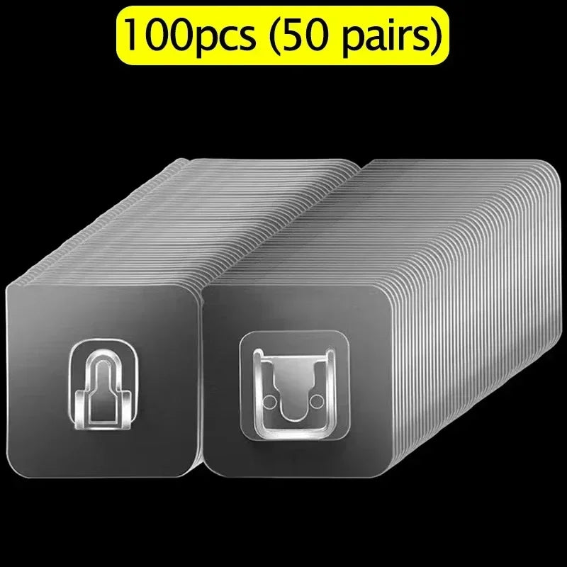 A package of 100 pairs of clear double-sided adhesive wall hooks shown in a box view.