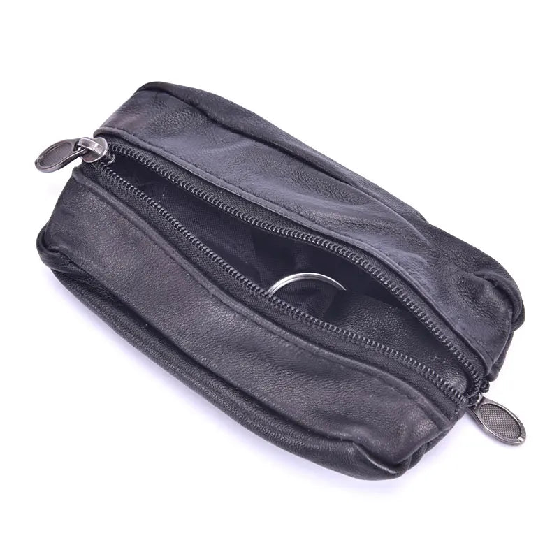 A black leather compact zippered coin purse with a metal key holder attached.