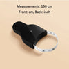 A black automatic retractable body measuring tape is shown next to a white tape measure for scale.