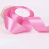 A roll of pink satin ribbon for gift wrapping and crafts, shown against a white background.