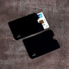 A set of black RFID blocking card sleeves and a UnionPay card are displayed on a brown textured surface.