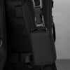 A close-up view of a black RFID wallet attached to a dark backpack strap.