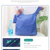 A blue polka dot fabric shopping bag is shown being held, with a glass bottle and green leaves in the background.