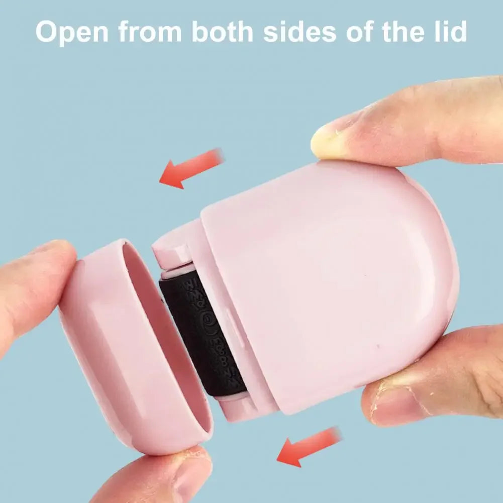 A hand opens the lid of a pink privacy protection roller stamp from both sides.