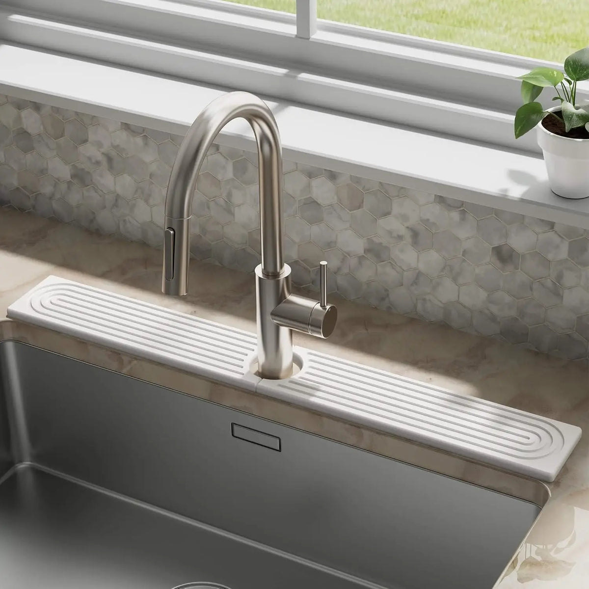 A modern stainless steel faucet mounted on a kitchen sink, with a rectangular stone tray for fast-drying water absorption.