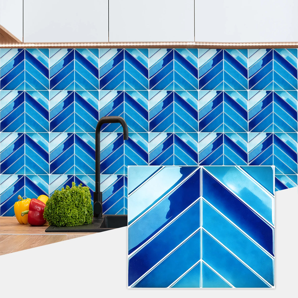 Blue and white chevron patterned marble peel-and-stick wall tiles installed on a kitchen backsplash.