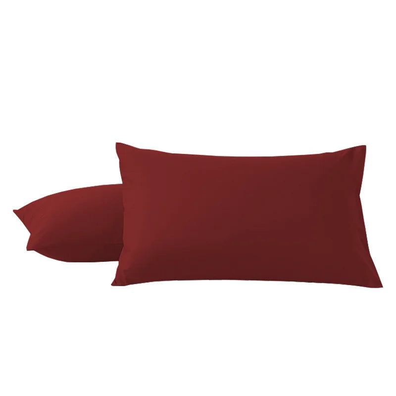 A pair of solid maroon microfiber pillowcases with envelope closure.