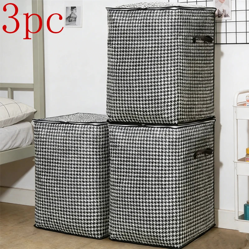 Three quilted storage bags in black and white houndstooth pattern standing vertically.