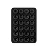 Black silicone suction cup phone holder mat with multiple circular indentations