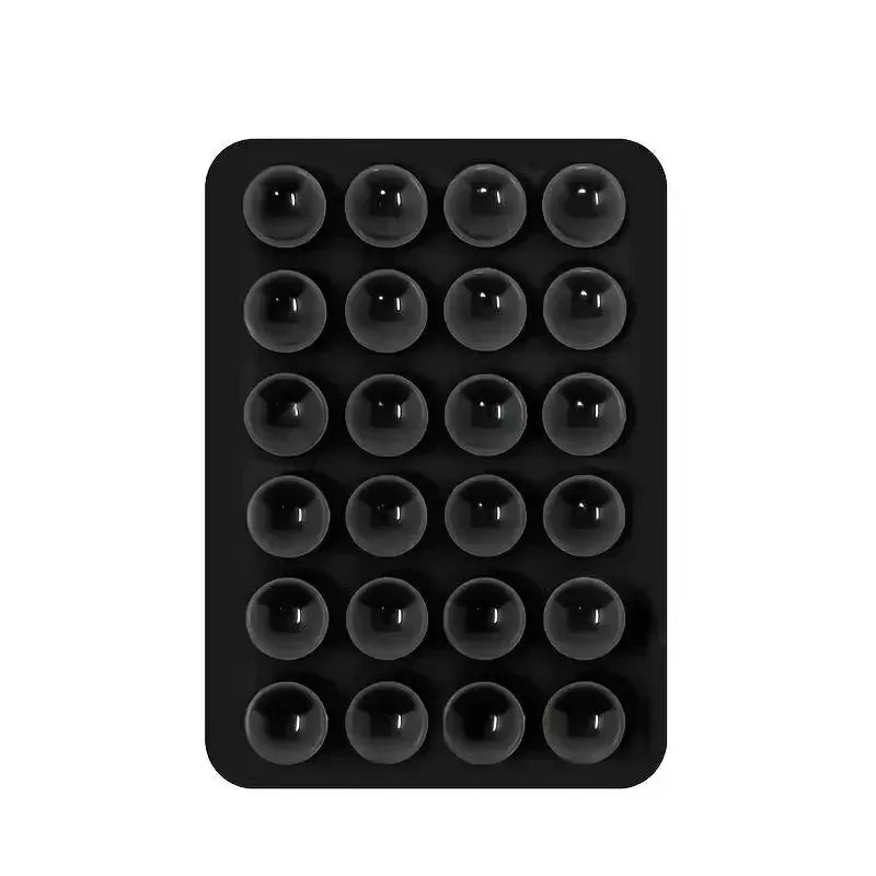 Black silicone suction cup phone holder mat with multiple circular indentations