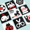 A collection of black and white high-contrast baby vision trigger cards featuring various silhouettes like a train, horse, an