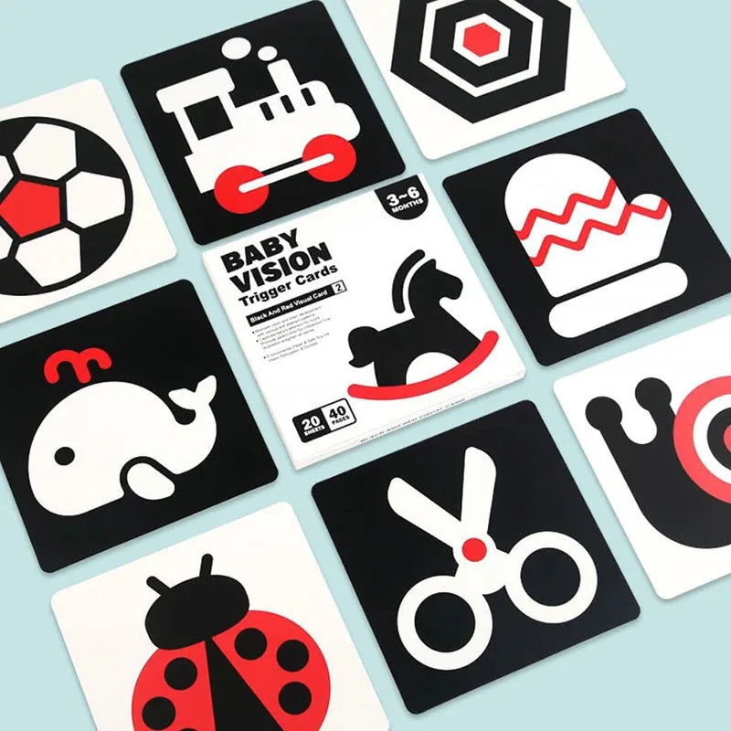 A collection of black and white high-contrast baby vision trigger cards featuring various shapes and objects like a train, ho
