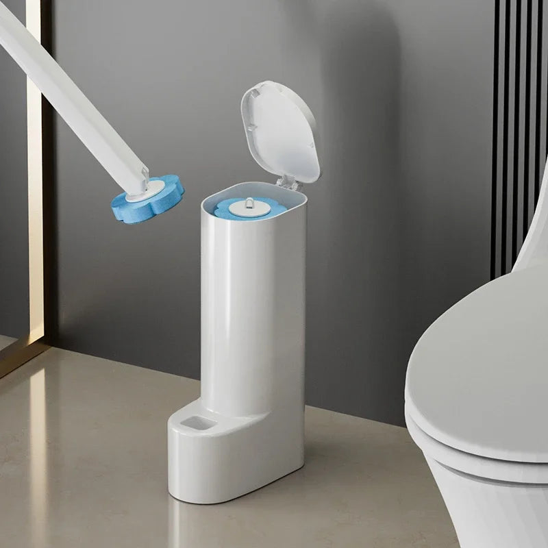A white disposable toilet brush set with a replaceable blue head is shown next to a toilet.