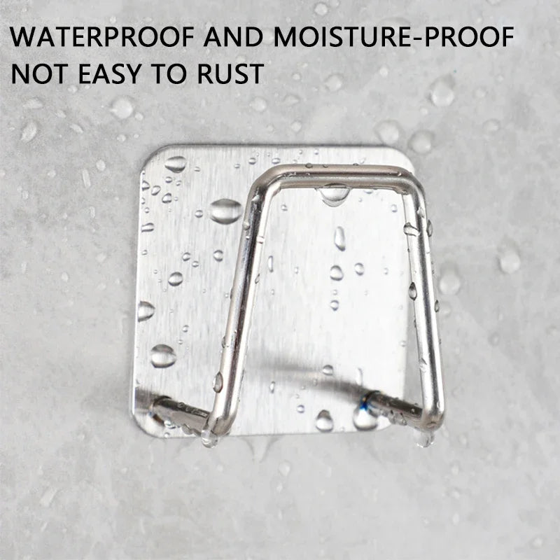 Stainless steel wall-mounted sponge holder with drain showing water droplets on the surface