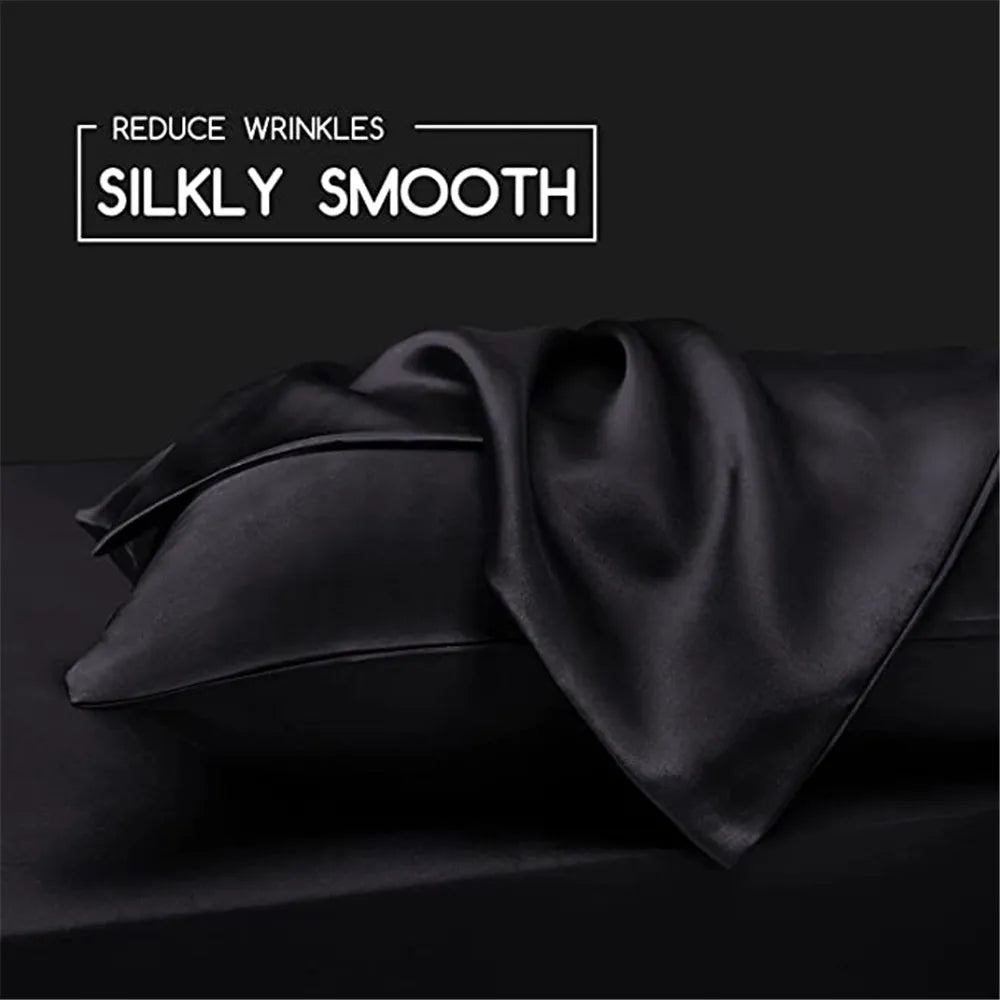 Black silky smooth satin fabric draped on a dark surface for hair and skin care.