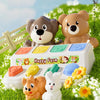 A white pop-up farm toy featuring two teddy bears and an orange dinosaur, set in green grass.