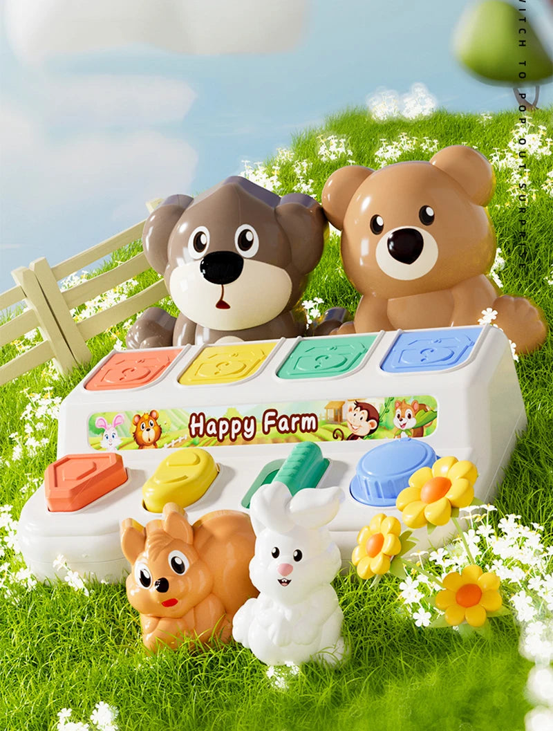 A white pop-up farm toy featuring two teddy bears and an orange dinosaur, set in green grass.