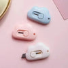Three small plastic cutters in pastel colors, including light blue, pink, and white.