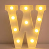 A glowing white LED letter night light shaped like the letter W, featuring multiple illuminated bulbs.