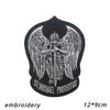 Black embroidery of an archangel with wings and a sword, featuring the text St. Michael Protectus.