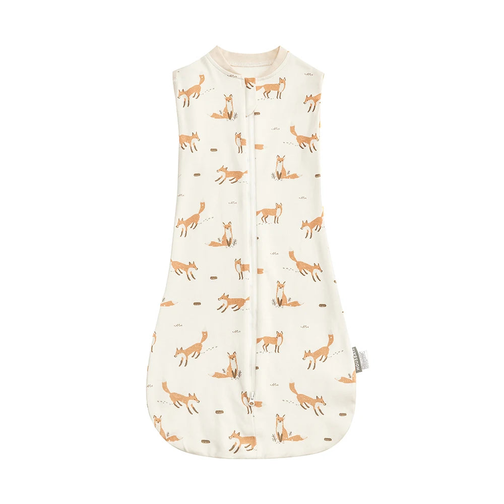 A cream-colored baby sleep sack featuring a repeating pattern of small orange and brown animal silhouettes.