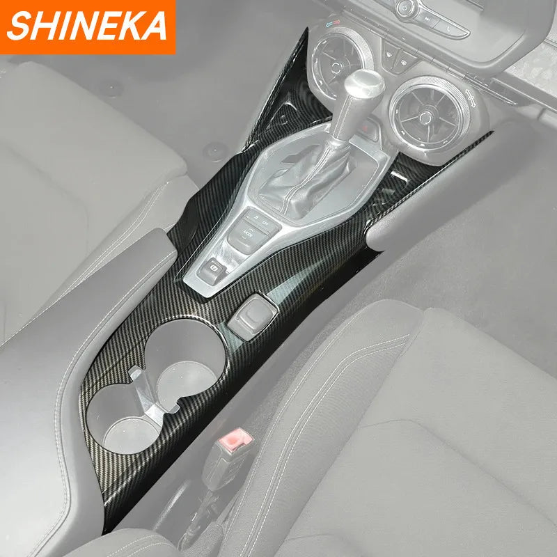Carbon fiber interior trim kit for a car dashboard showing controls and accents.