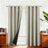 Light beige double-layer blackout curtains hanging in a window frame.