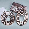 A set of wooden embroidery hoops for cross-stitch and needlework, featuring various sizes.