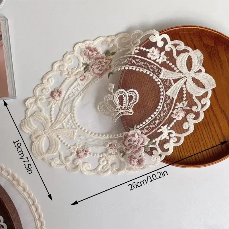 Elegant oval white lace embroidery wreath on a wooden placemat