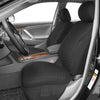 A black car seat covered with a honeycomb mesh fabric inside a vehicle cabin.