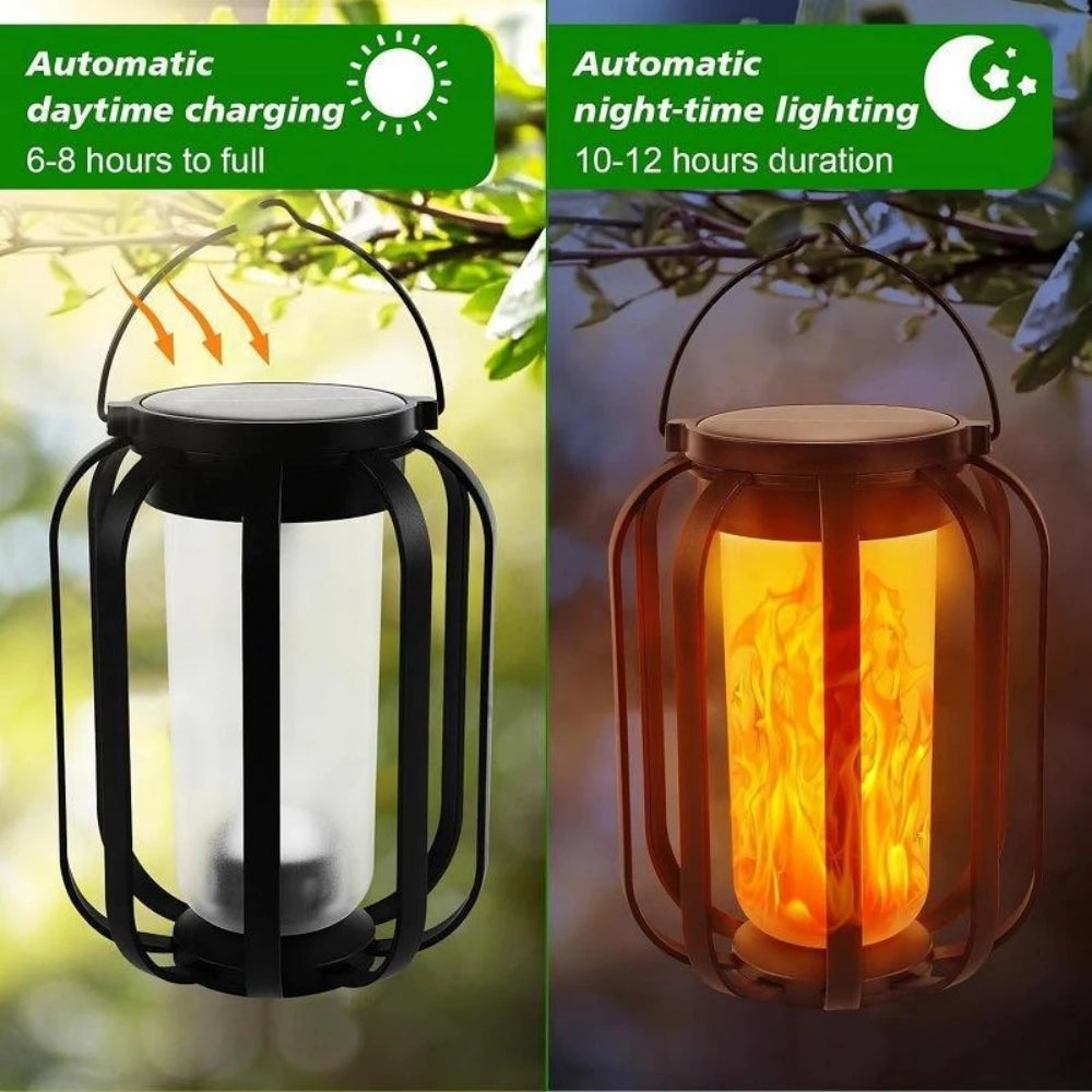 A black solar flickering flame lantern hanging outdoors, illuminating a warm orange glow.