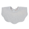 A light gray knitted baby bib in a bandana style with a small button closure.