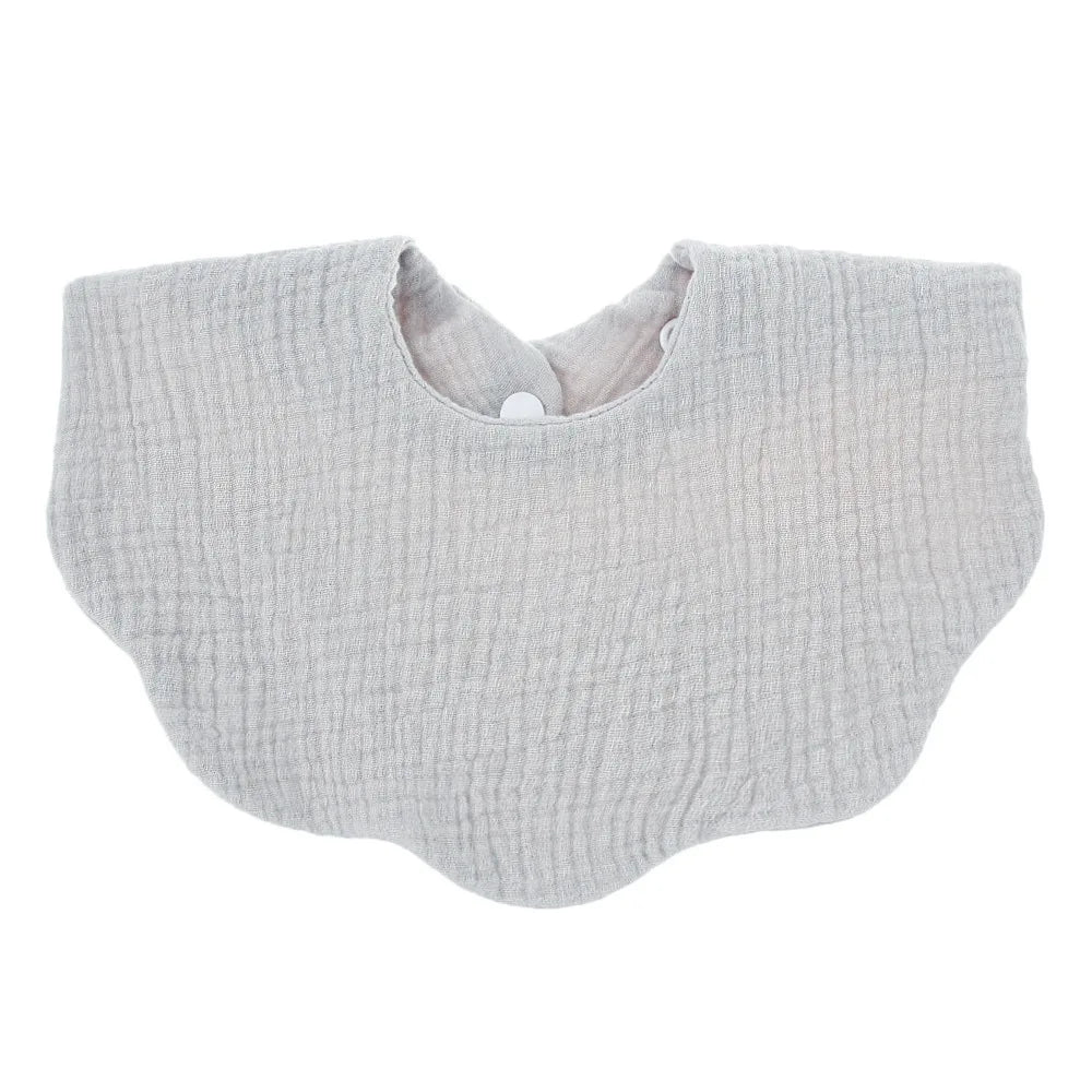 A light gray knitted baby bib in a bandana style with a small button closure.