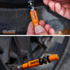 An orange and black auto-stop tire deflator kit is shown being held by a hand, with the product visible against a tire.
