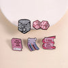 A set of enamel pins featuring text related to books and reading on a light background.