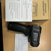 A black digital infrared thermometer is shown next to its packaging and a product information sheet.