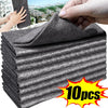 A stack of gray microfiber cleaning cloths is shown next to a hand, indicating a multi-pack product.