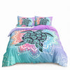A set of sea turtle patterned duvet covers and pillows in teal, purple, and pink tones.