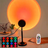 A black sunset projection light is shown next to a remote control and a potted cactus on a table.