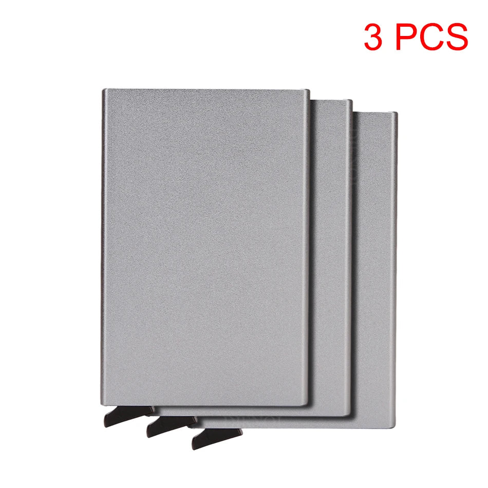 Three slim gray metal RFID blocking card holders with a pop-up design