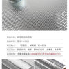 Roll of brushed silver peel-and-stick metal wallpaper shown next to a small glass jar.