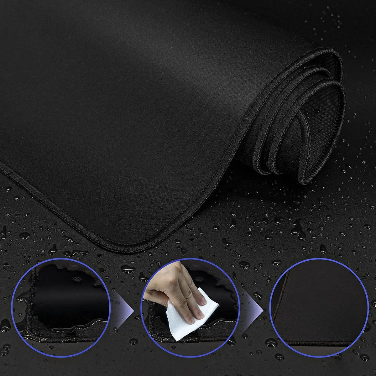 Black extended anti-slip desk pad with stitched edges shown rolled and being touched