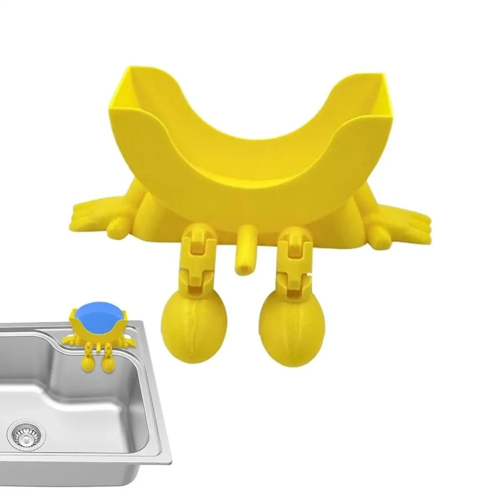 A yellow 3D sponge holder with a hanging design is shown next to a kitchen sink.