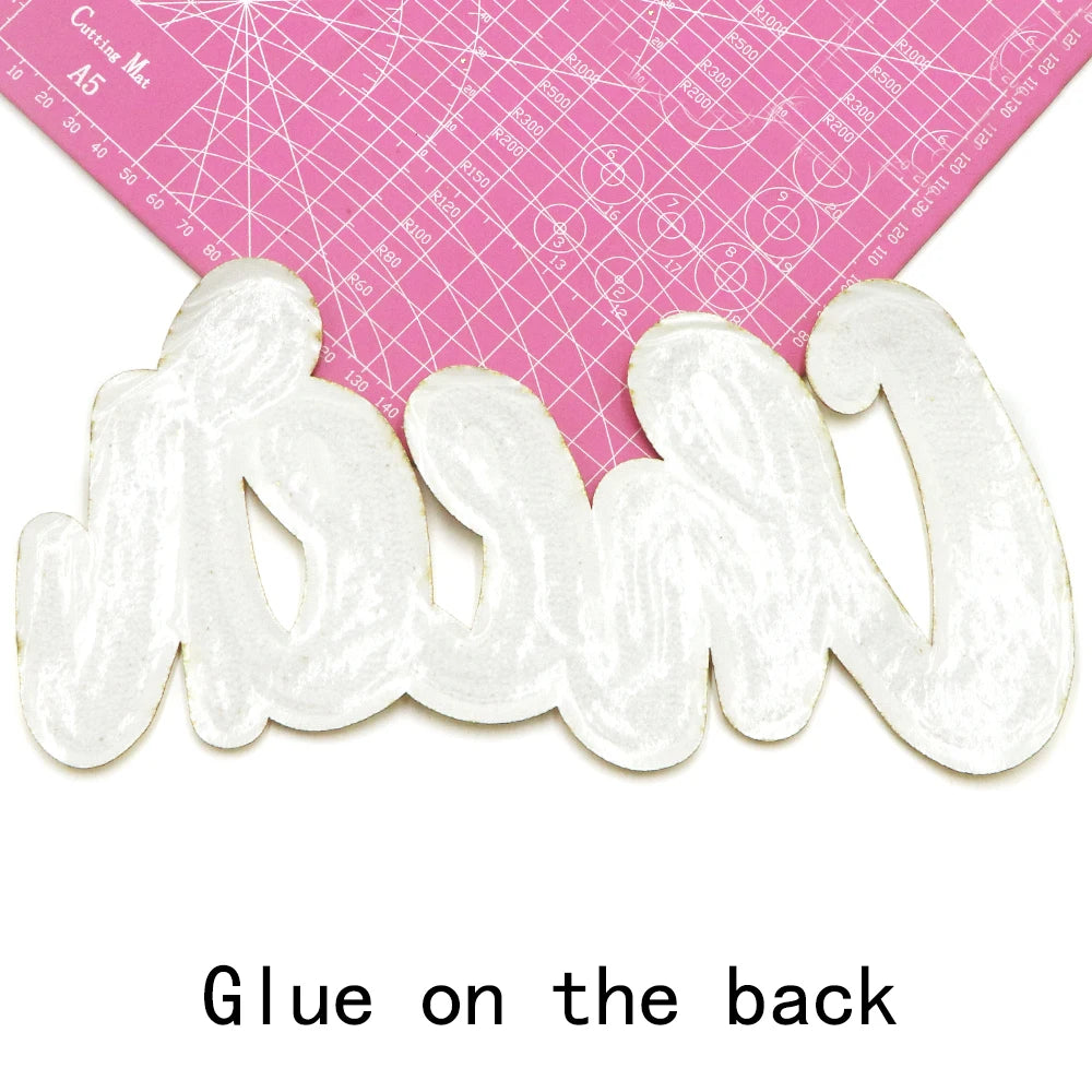 White chenille letter patch for DIY clothing and accessories shown next to a pink ruler.