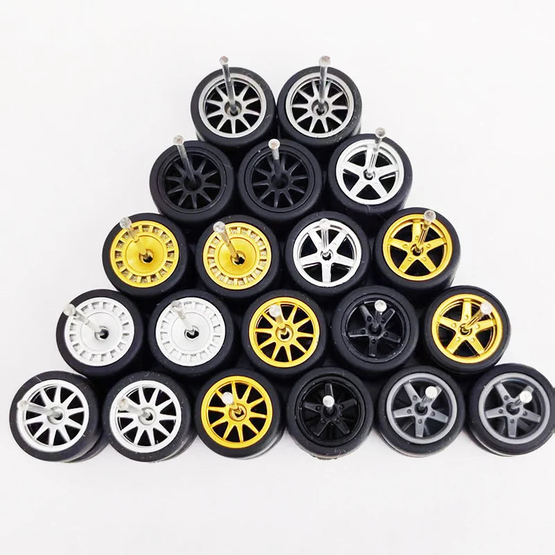 A collection of ten pairs of 1:64 scale alloy car wheels and tires stacked in a pyramid formation.