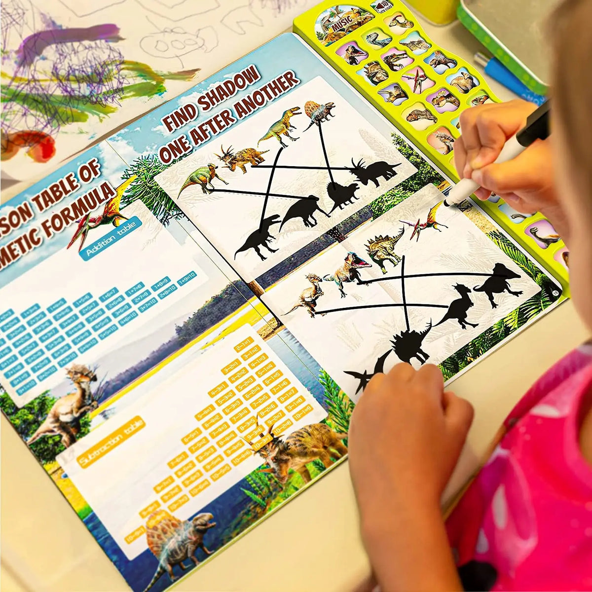 Ein Kind benutzt ein interaktives Dinosaurier-Busy Book, um Schatten zu finden und Formeln zu vervollständigen.