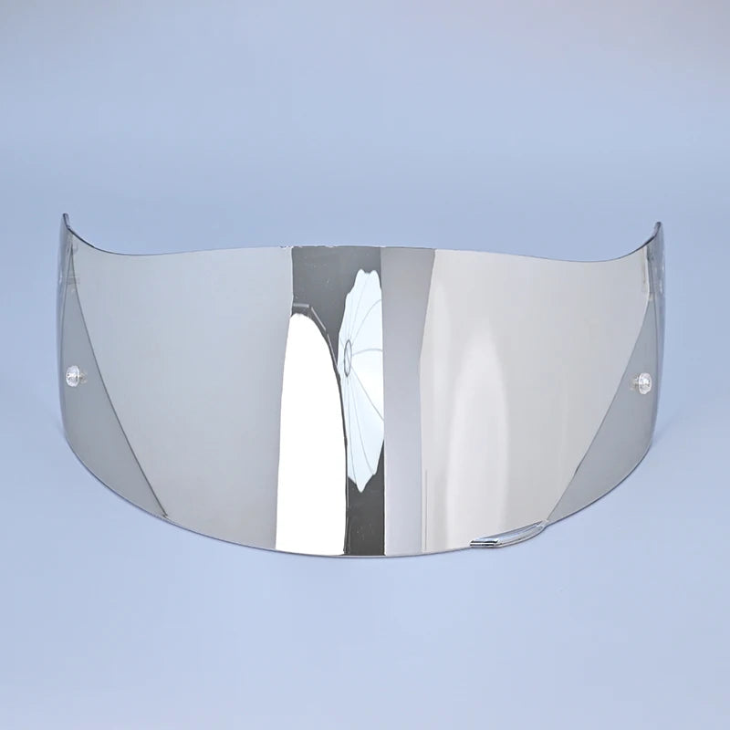 A silver motorcycle helmet visor lens shield displayed against a light blue background.